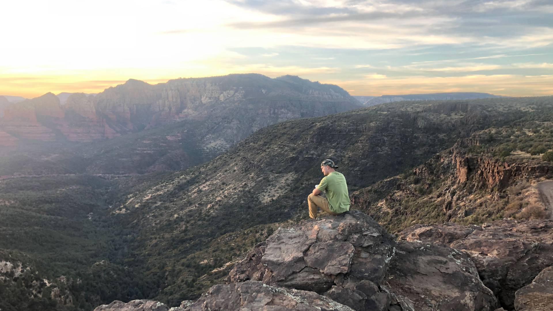 Person sitting on mountaintop in Sedona, Arizona