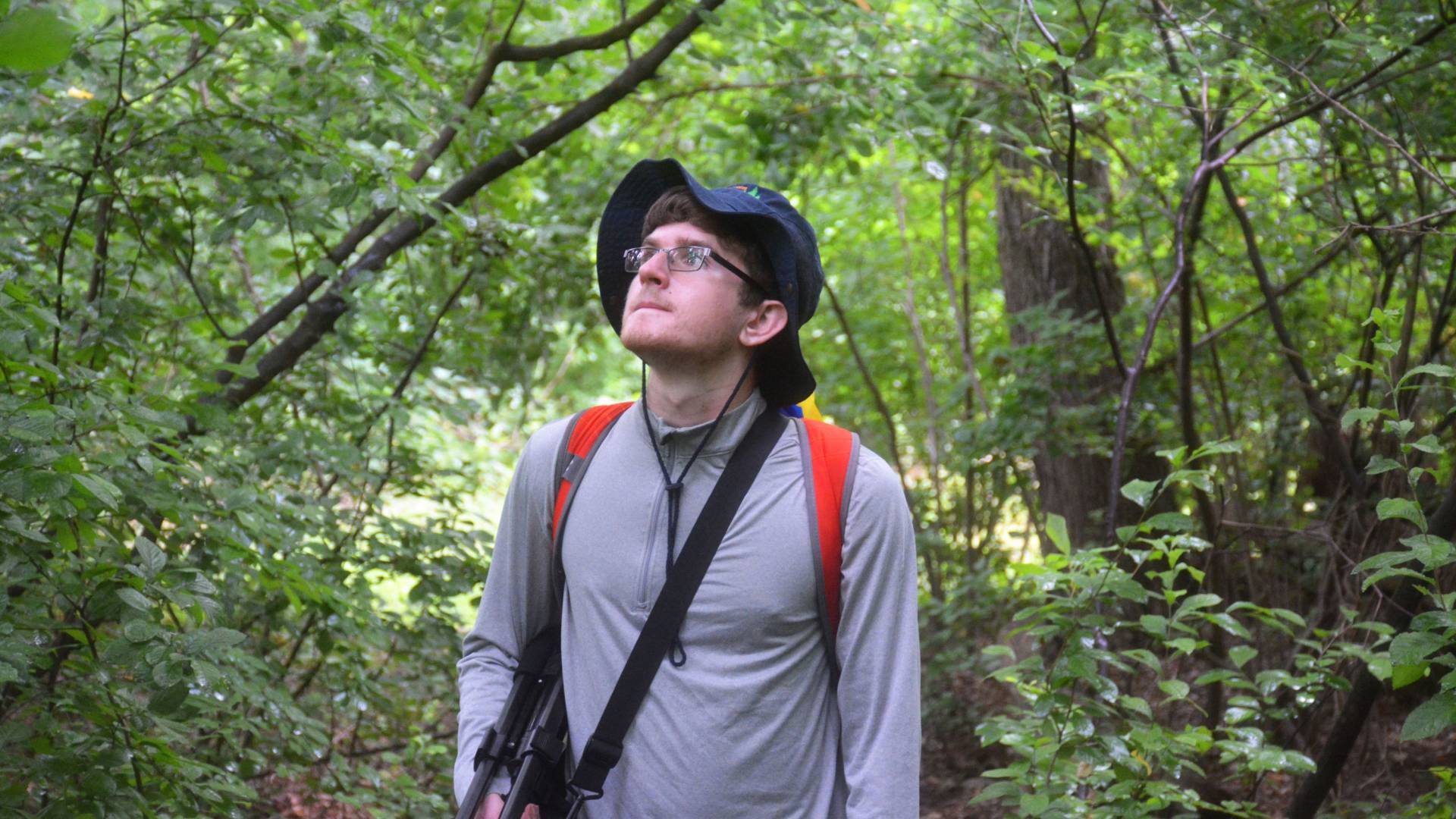 Joe Kawalec in a forest, carrying camera equipment