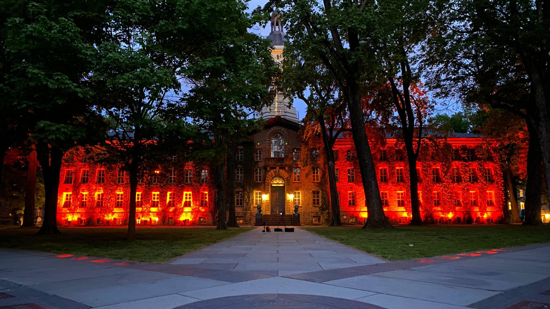 Nassau Hall bathed in orange light