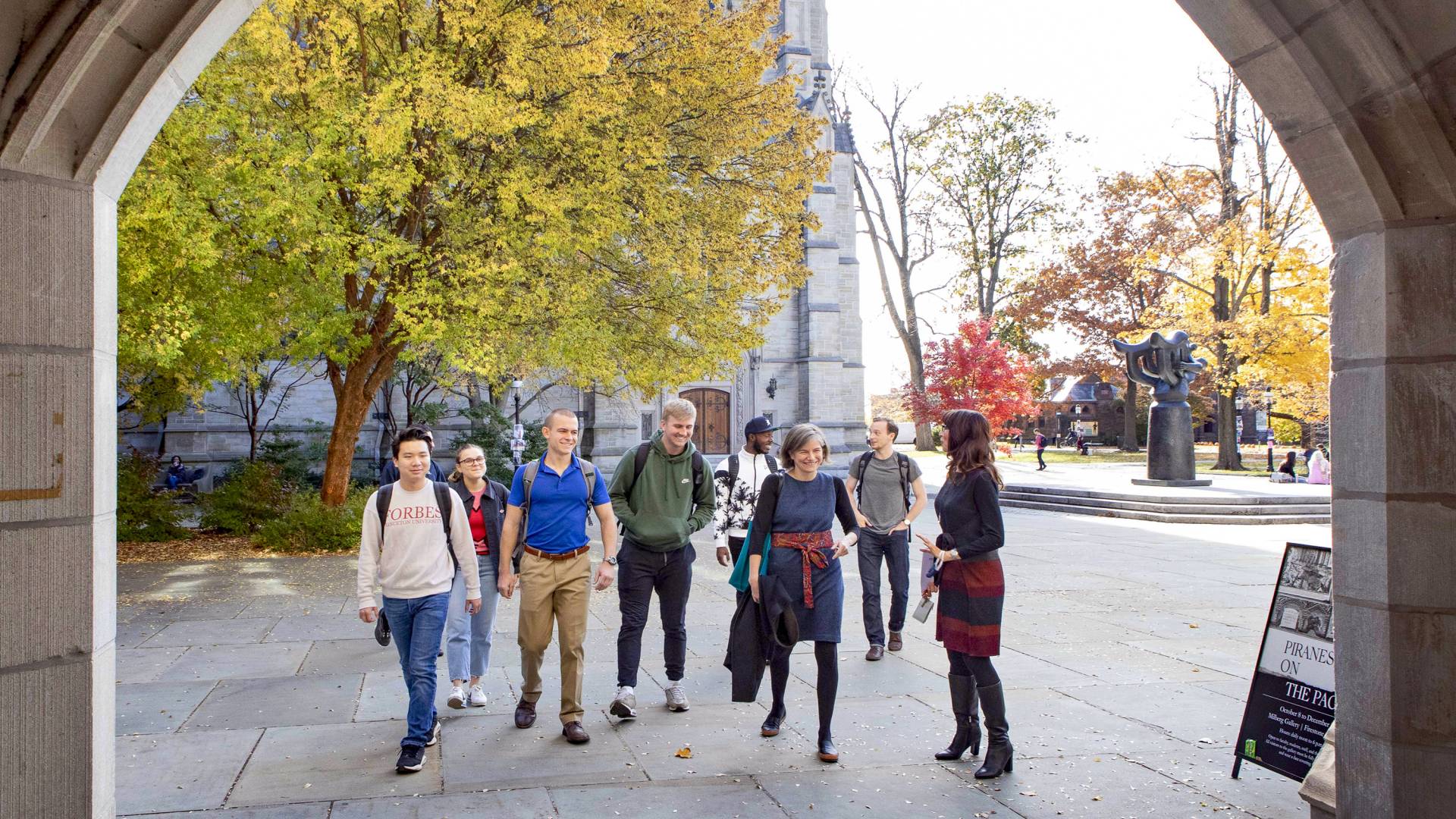 Students and professors walk toward Firestone Library