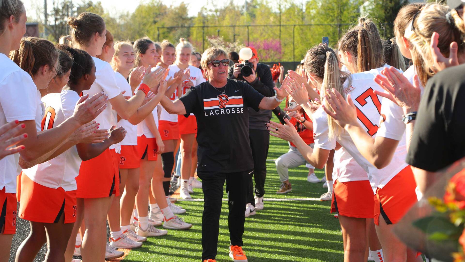 Chris Sailer congratulating the women's lacrosse team