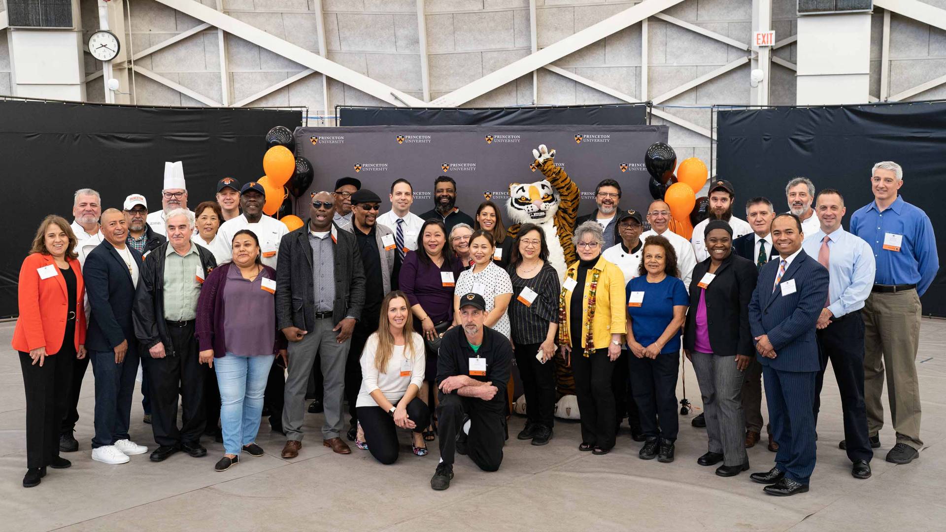 Members of the Campus Dining staff gather with the Princeton tiger. 