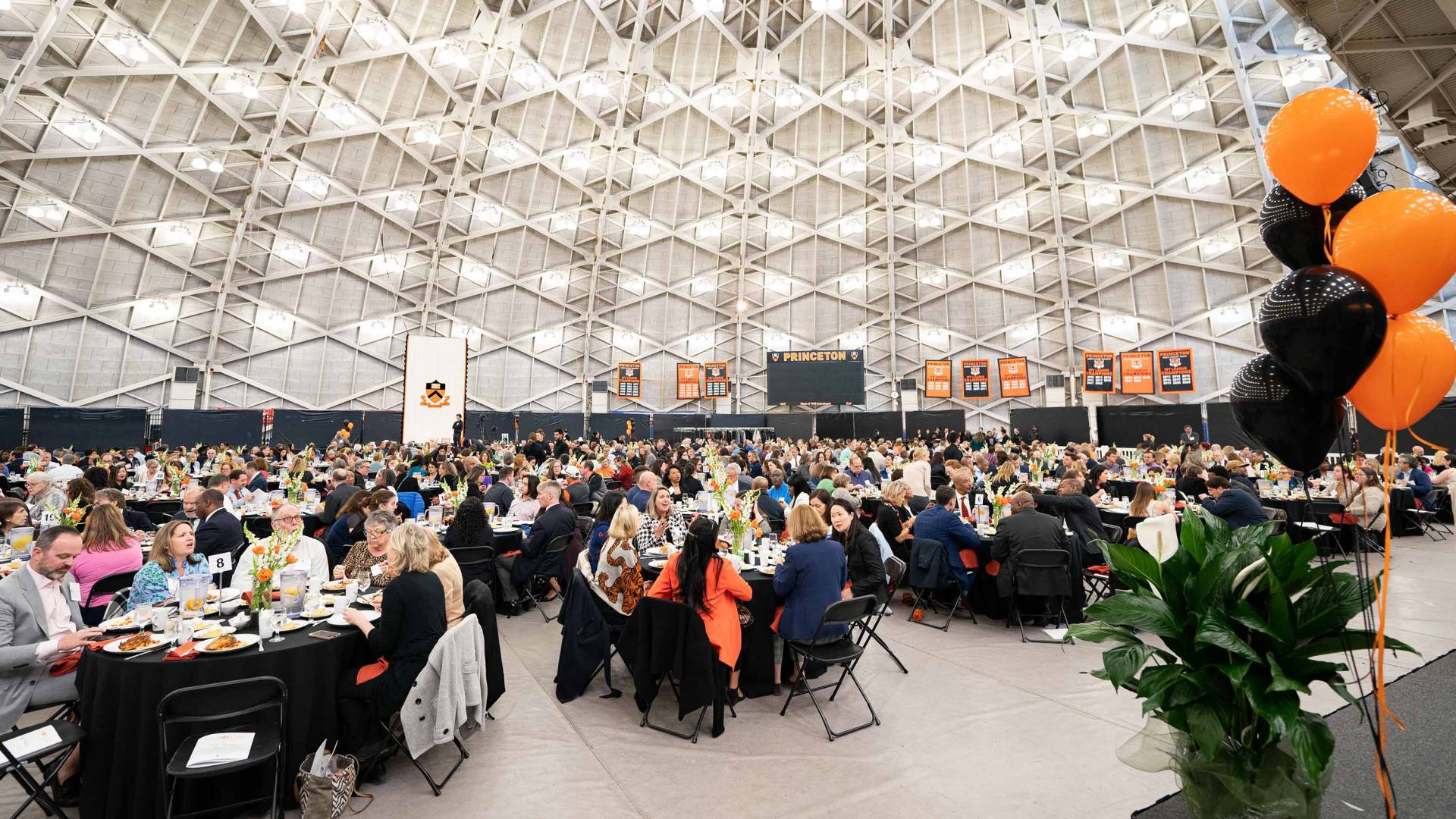 Diners converse during the luncheon at Jadwin Gym, bedecked in orange and black.