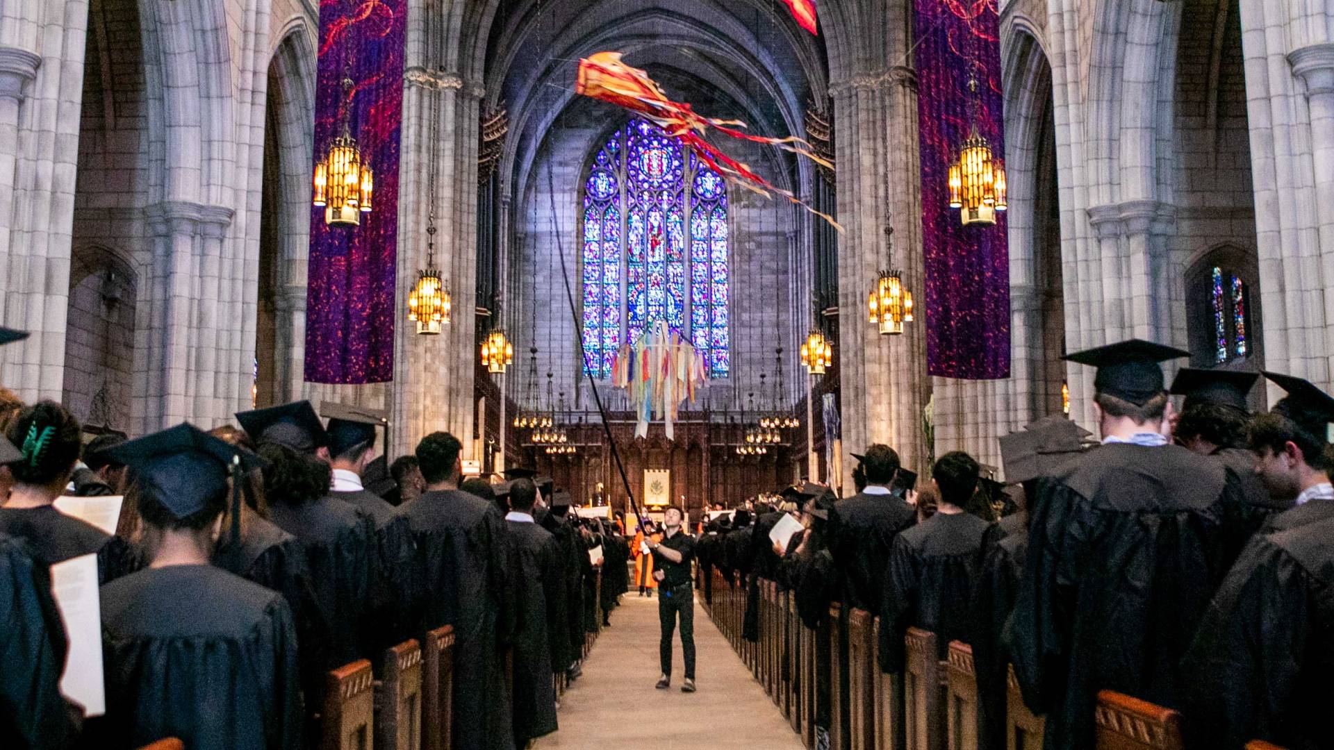 Interior of chapel as the kites fly and graduates await the start of the ceremony