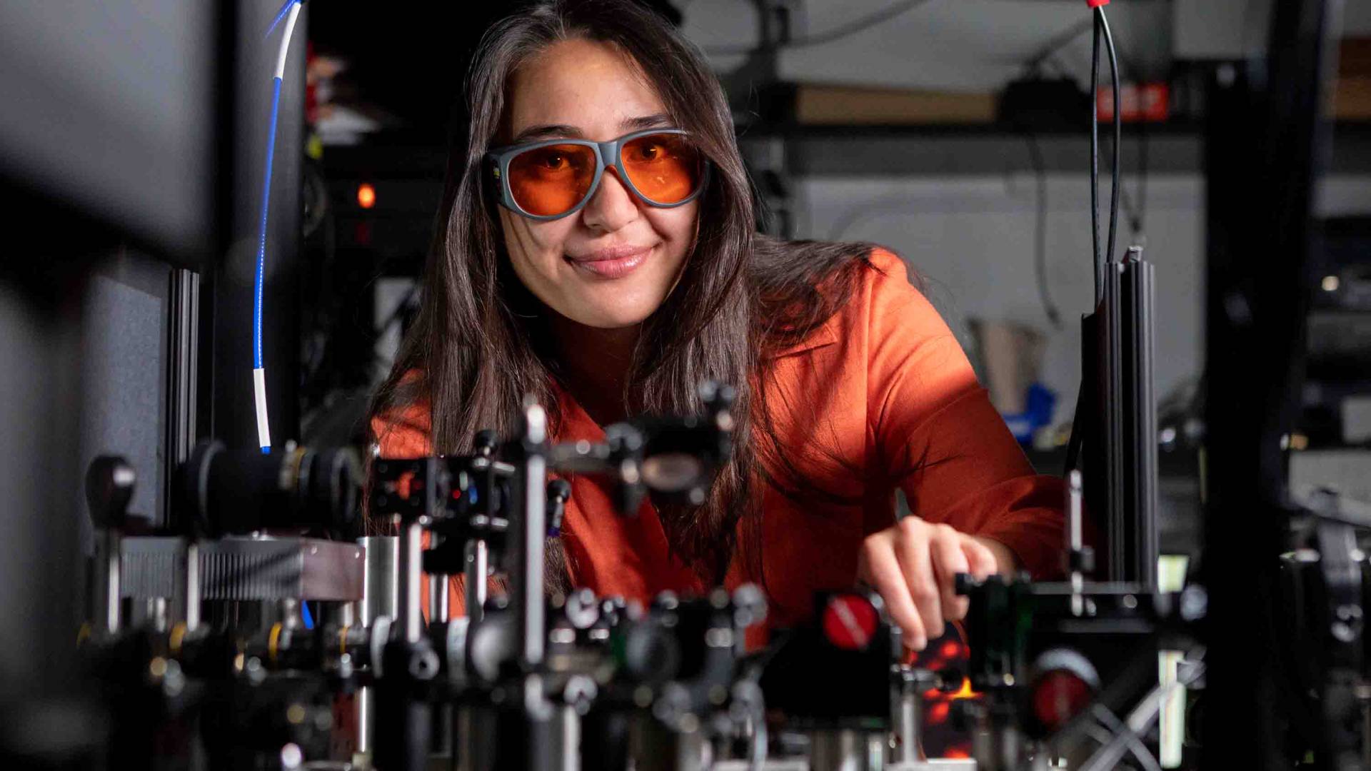 Elisabeth Rülke smiling in a lab with goggles.