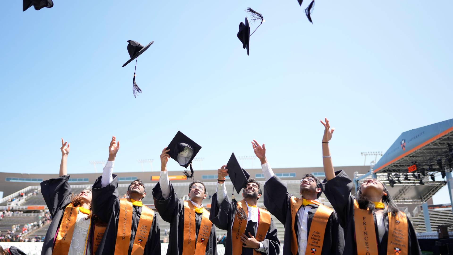 Graduating students throwing hats up
