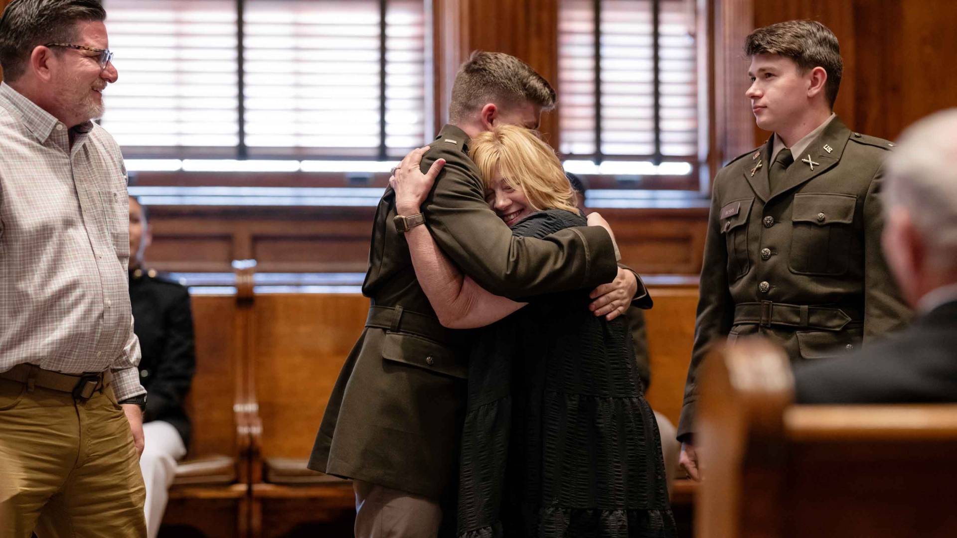 New ROTC cadet hugging family members