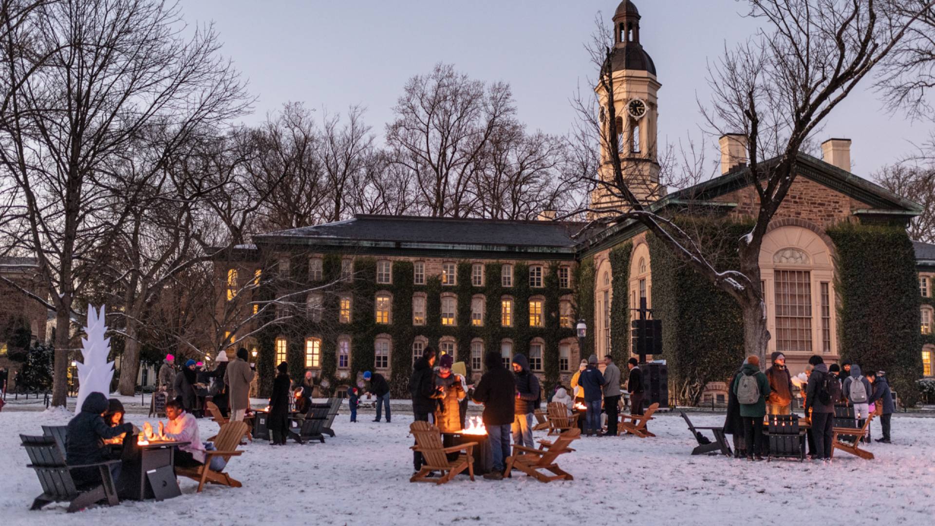 Students stay warm thanks to campfires set up on Cannon Green as part of the Wintersession Kick-off Festival. 