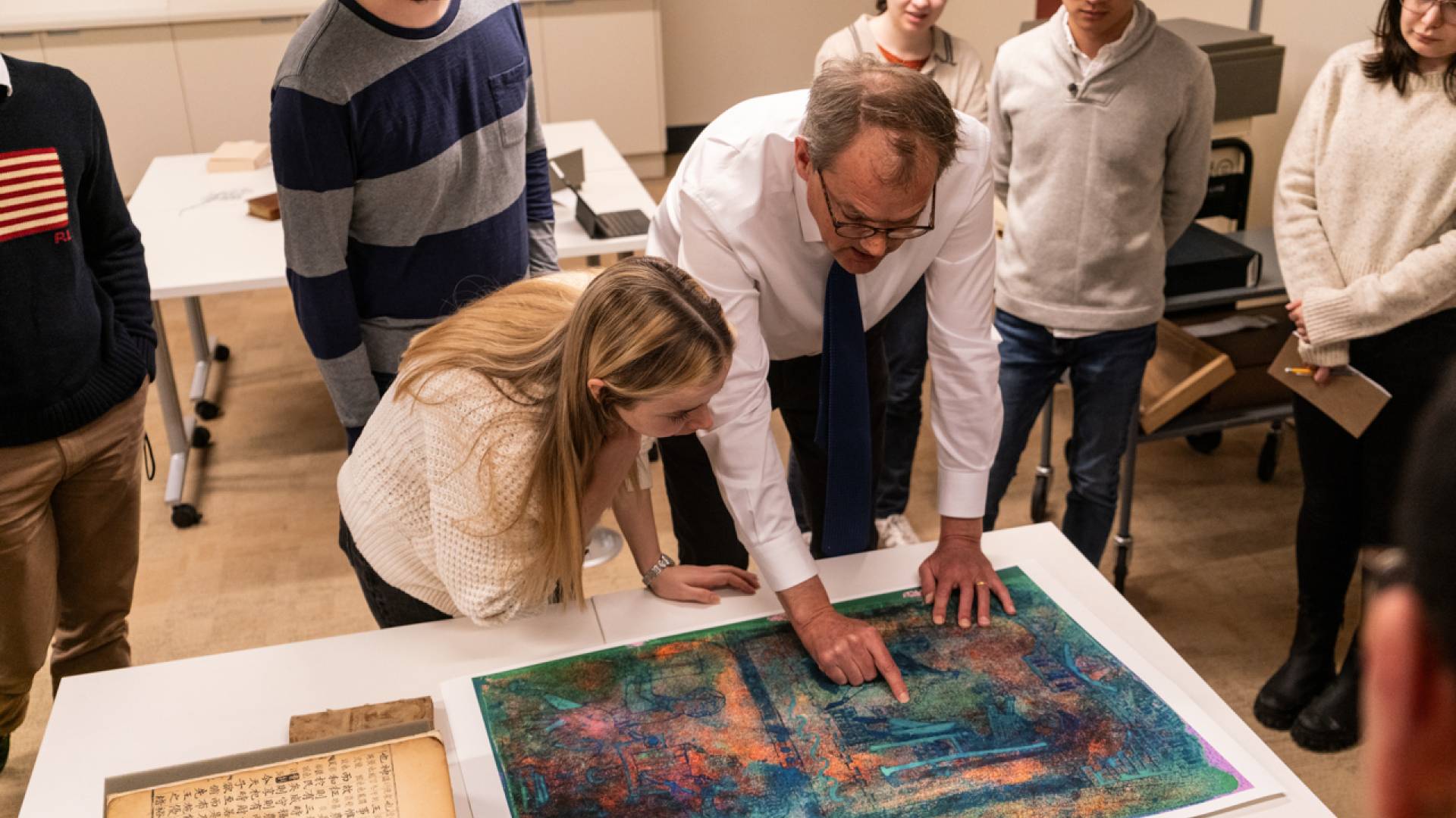 William Noel (right), the John T. Maltsberger III ’55 Associate University Librarian for Special Collections, shows undergraduate and graduate students a detail from a medieval manuscript housed at Princeton University Library's Department of Special Collections. 