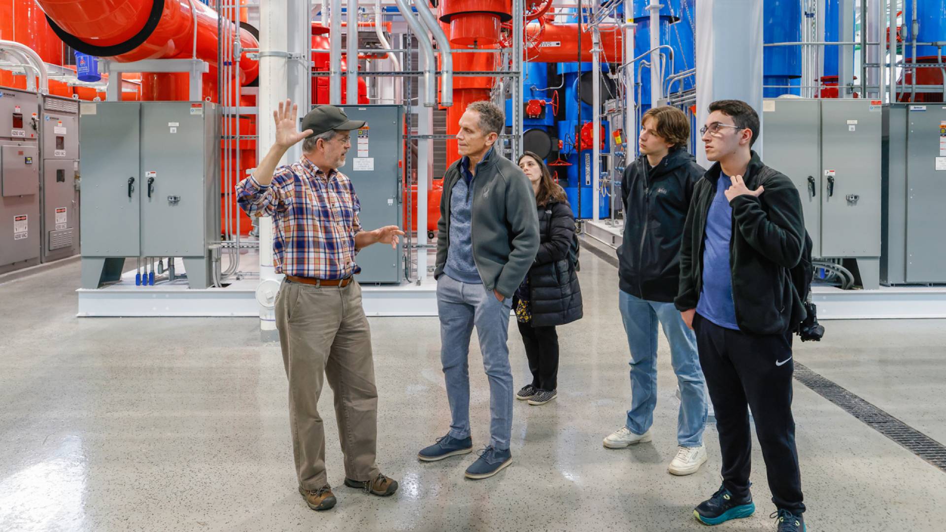 Ted Borer (left), director of the energy plant, leads a tour of the TIGER facility, which was recently featured in a New York Times story about the University's geo-exchange energy system. 
