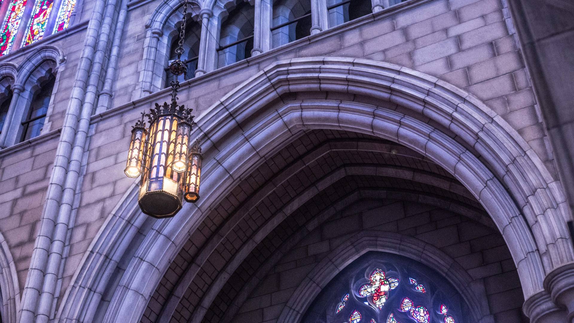 A lit chandelier inside the Princeton University Chapel