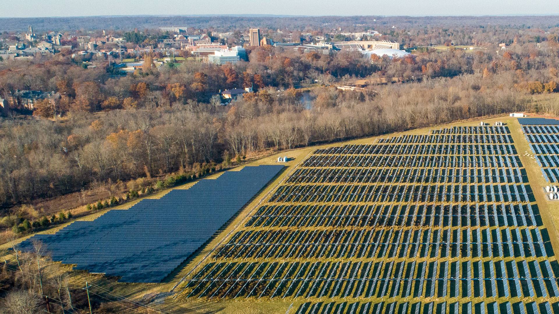 Field of solar panels with municipality of Princeton in background