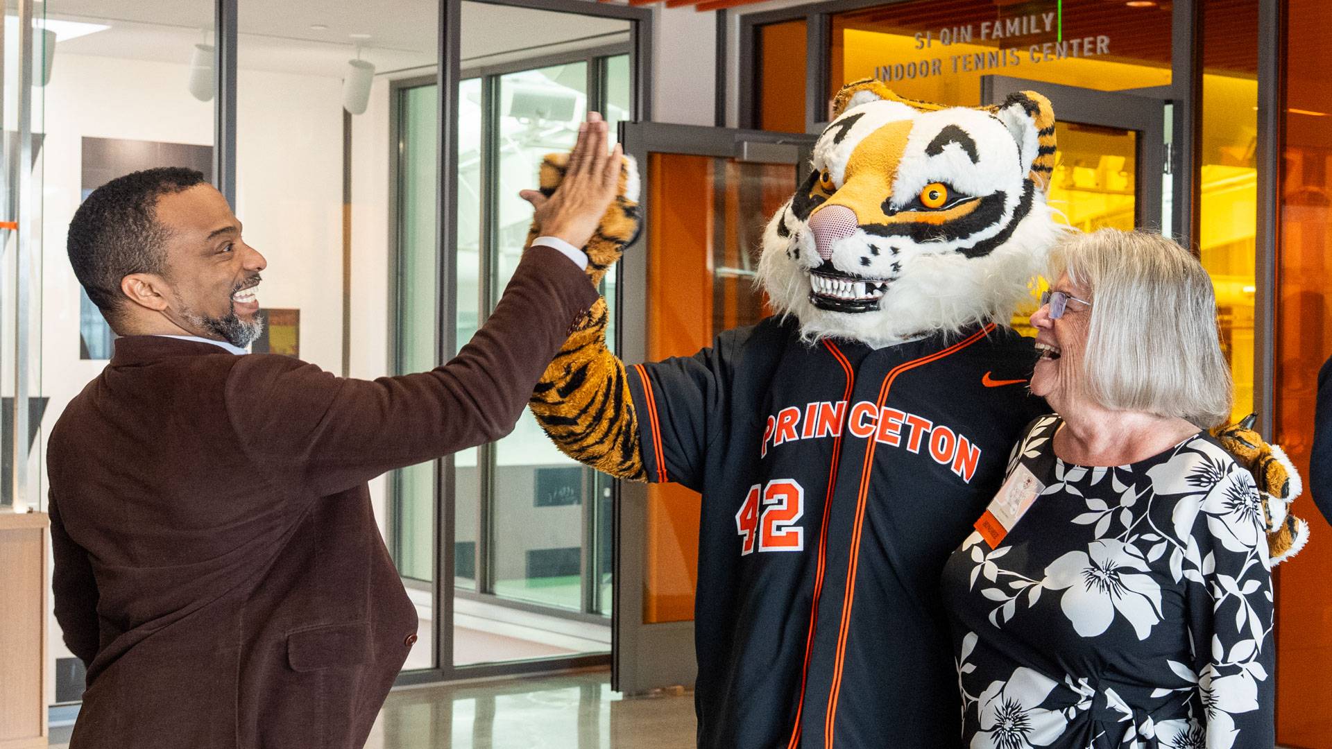 Princeton tiger high fives a staff member