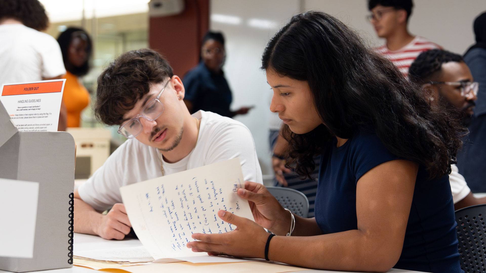 Two students examine the Toni Morrison Papers through the Lydia’s Scholars Program