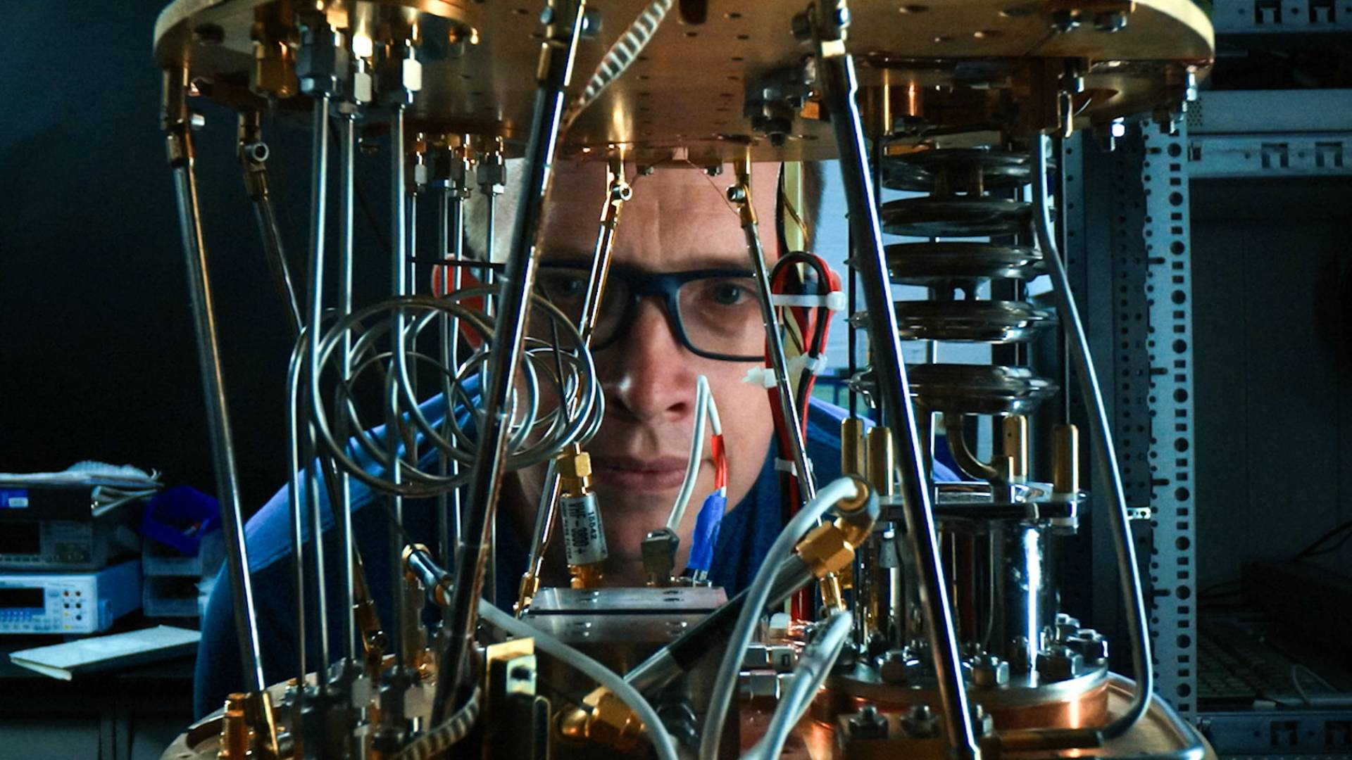 Andre Houck looking at quantum computer closely.
