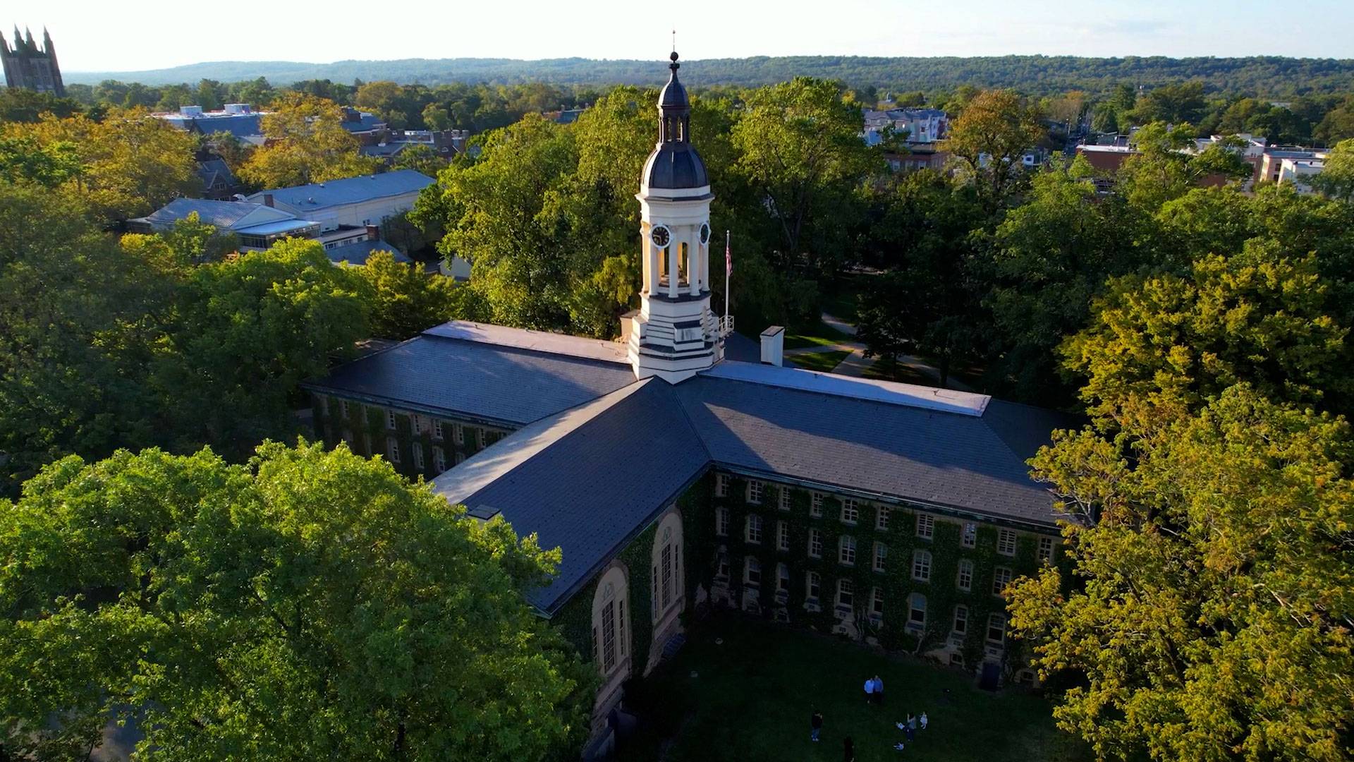 Nassau Hall surrounded by trees.