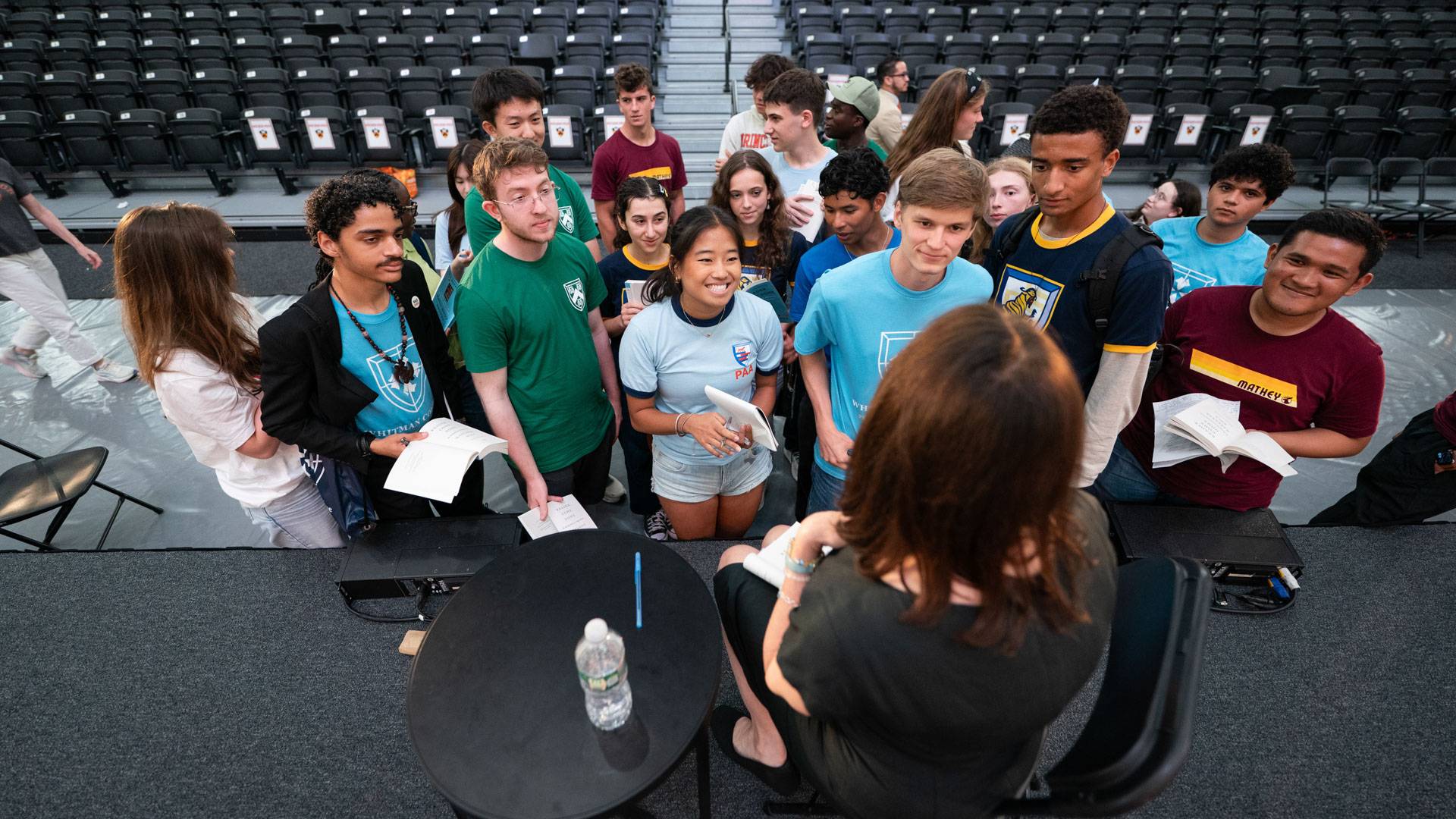 Students gather around author Maryanne Wolf after the event.