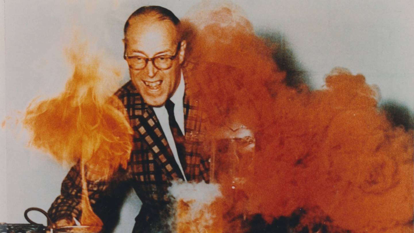 Hubert N. Alyea '25 in lab with orange smoke