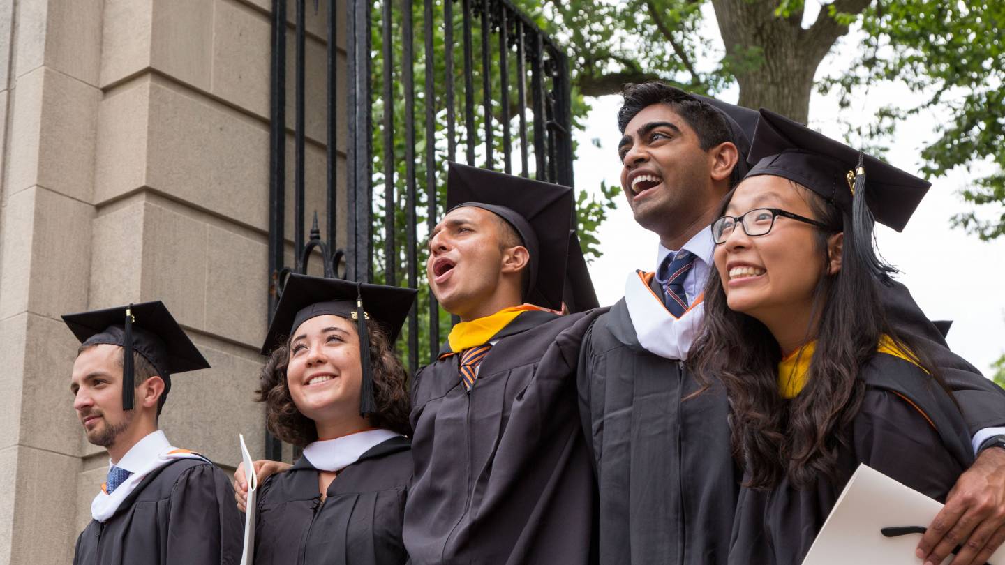 Students exiting FitzRandolph Gate after graduation