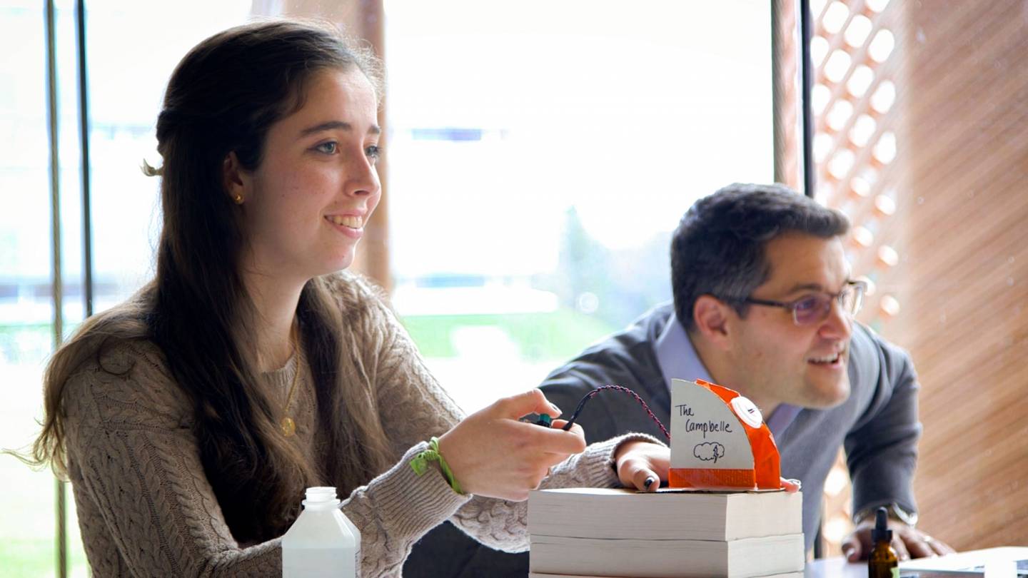 Sylvie Thode launching rocket while professor Joshua Shaevitz watches