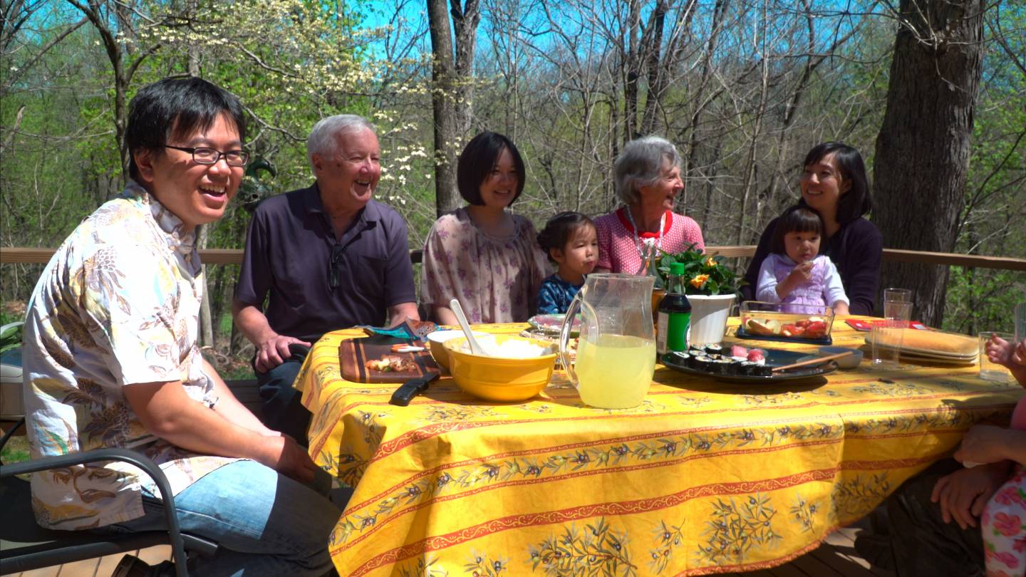 So Kubota with his family and host family eating outside