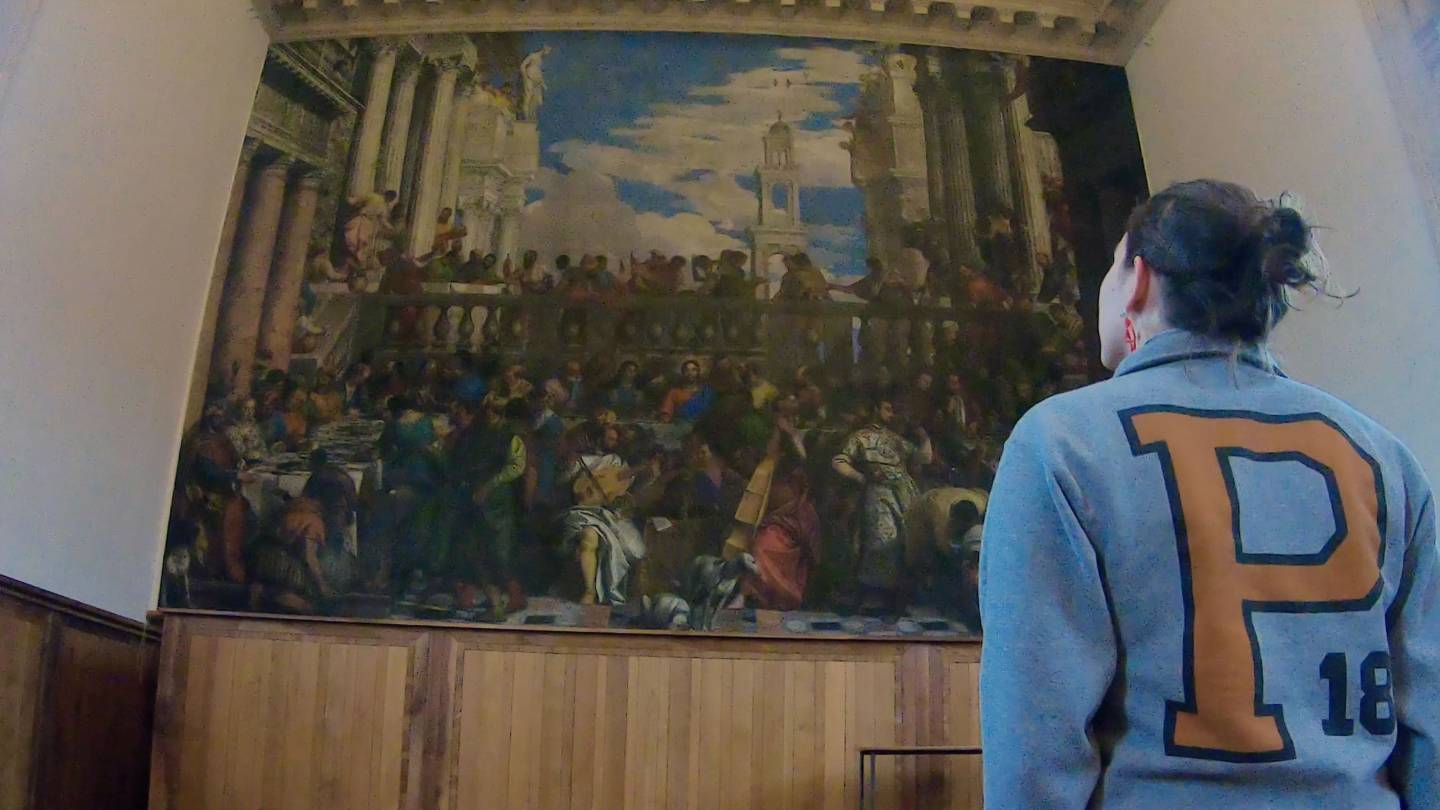 Sofia Feist looking at Feast of Cana painting