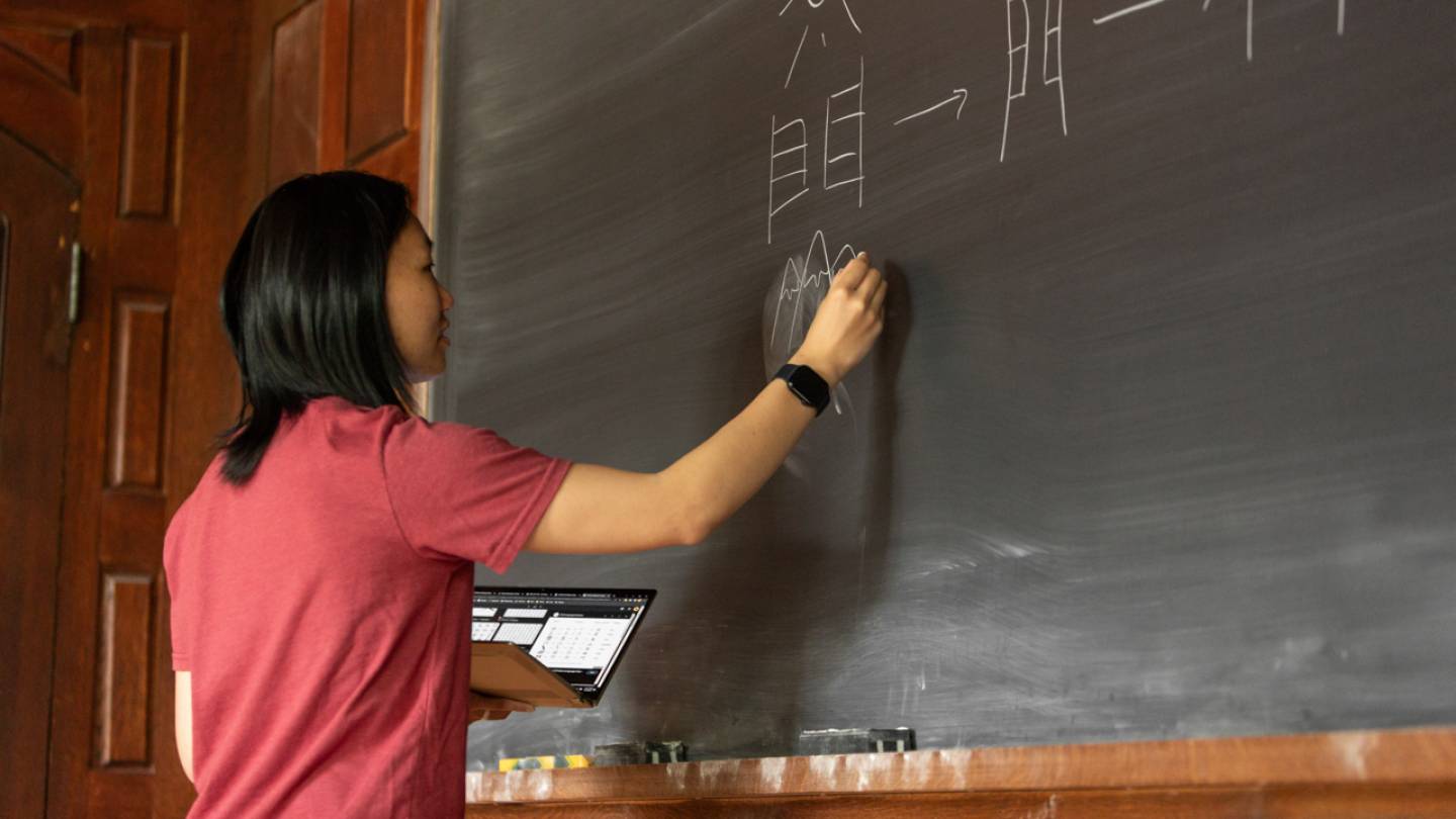 Megan writing on the blackboard