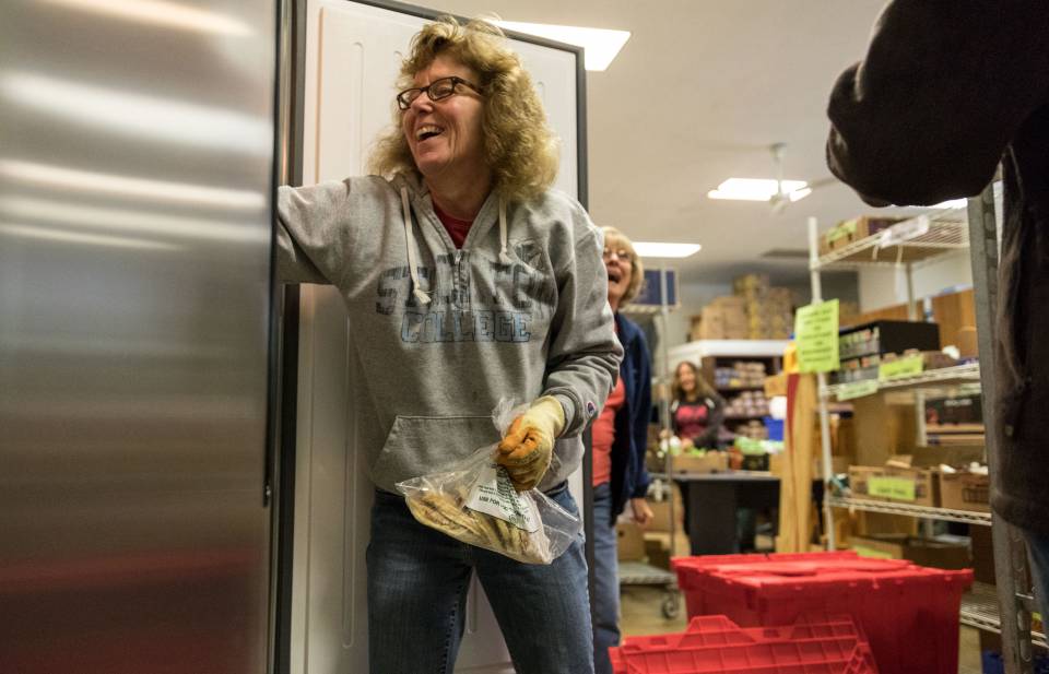 Bentley volunteer loading food into freezer