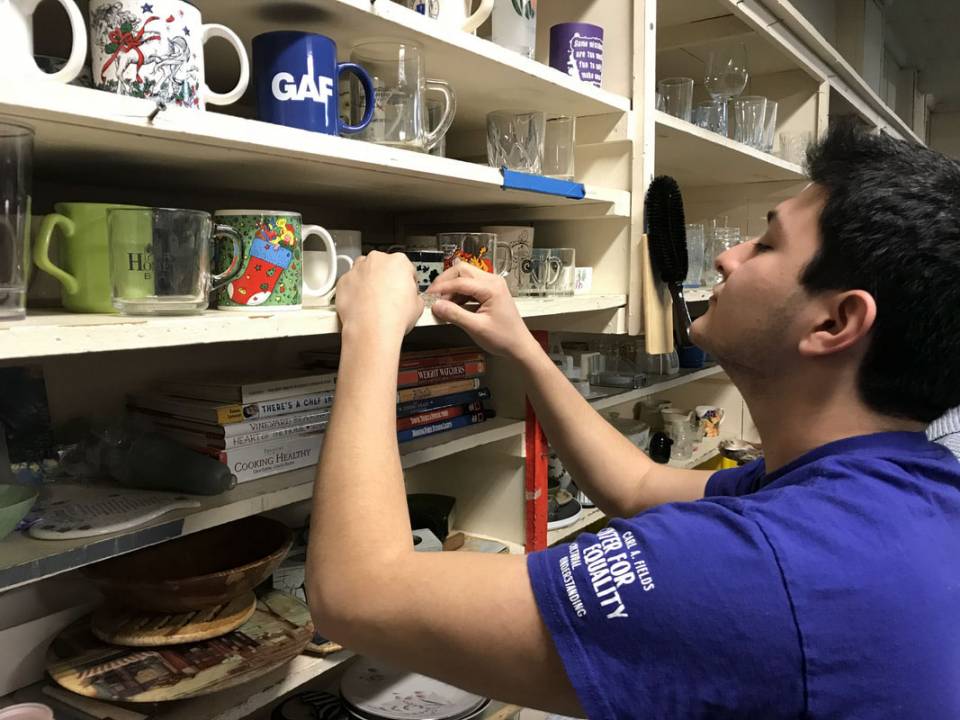 Student stacking shelves in HomeFront