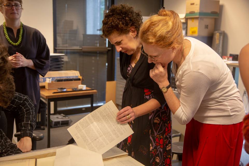 Professors looking at journals from the 1930s at Art Museum