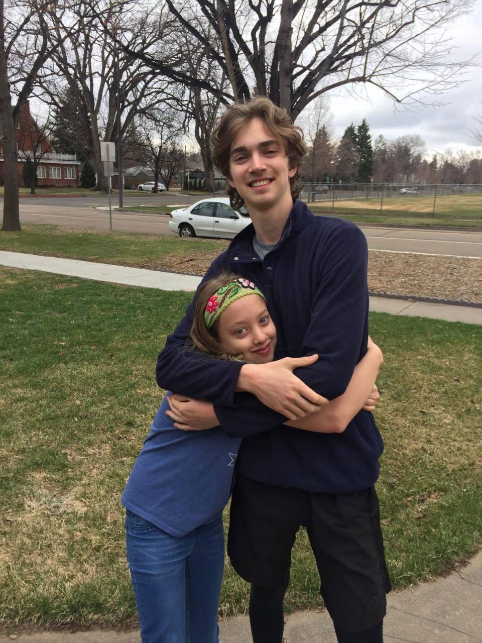 A student poses with his sister