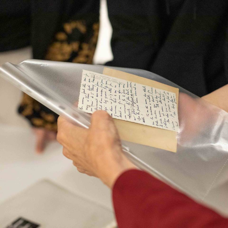 A person holding old documents