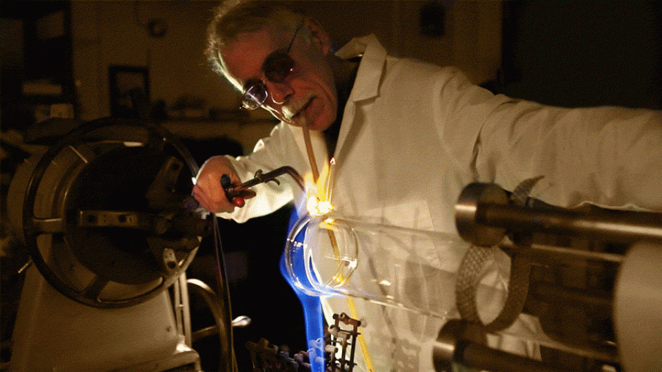 Souza blowing to control flame on glass