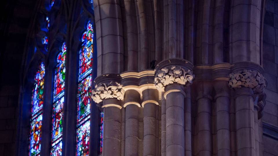 Stained glass window and pillar inside University Chapel