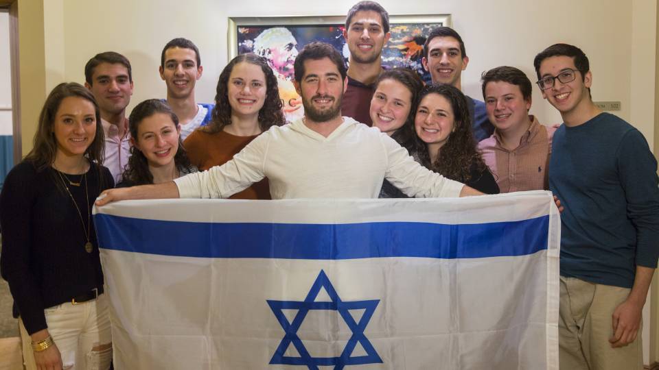 Jewish Life students holding Jewish star flag