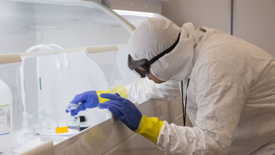 Researcher working in clean room.