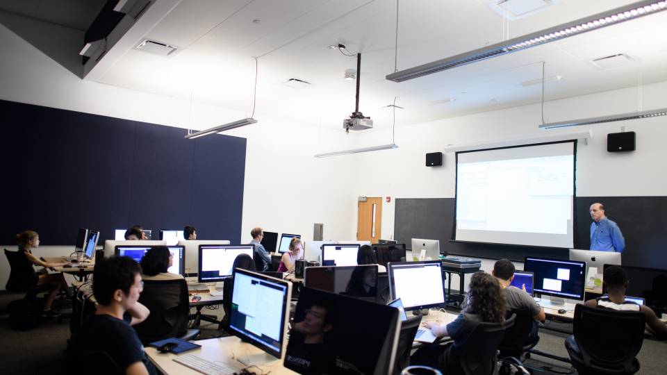 Students in front of computers in lecture hall