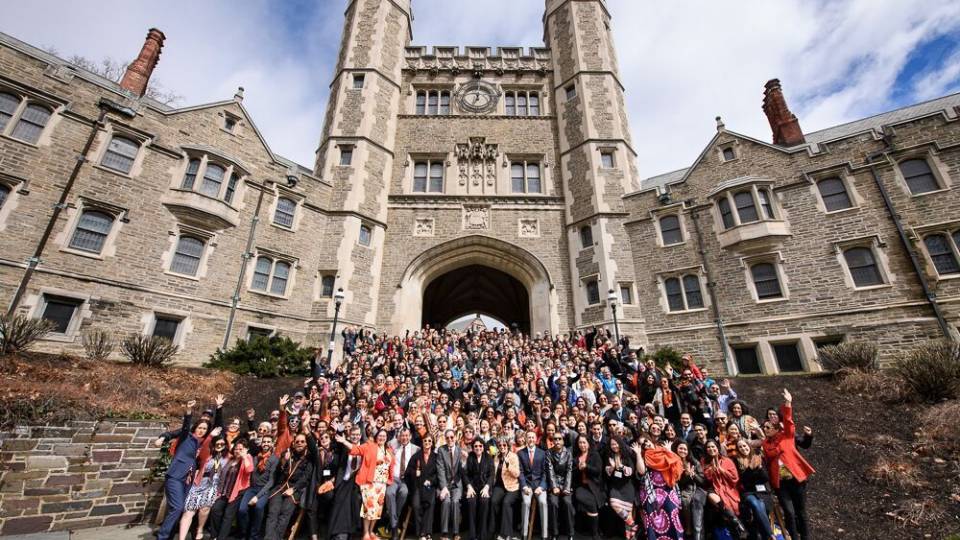 Latino alumni pose for a group photo before Blair Arch.