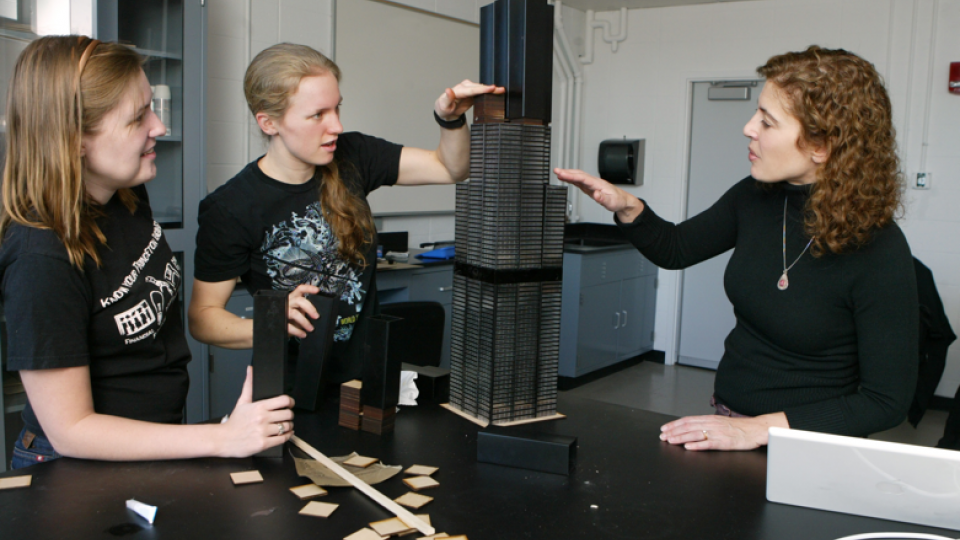 Professor Maria Garlock shows students a model of a skyscraper.