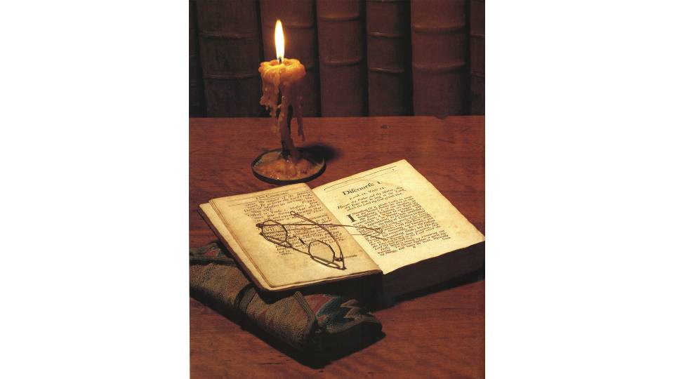 Book and candle on a desk