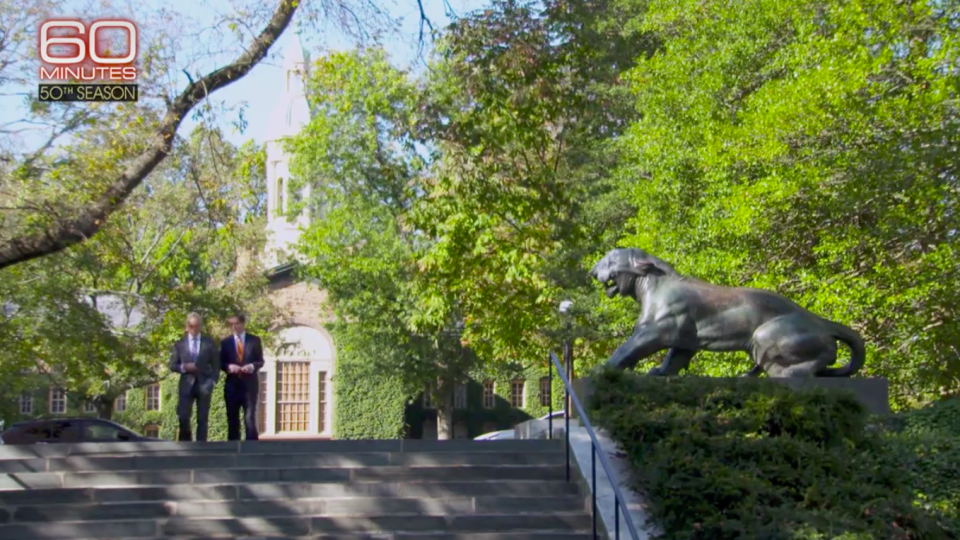 President Eisgruber walks on campus with "60 Minutes" correspondent Scott Pelley.