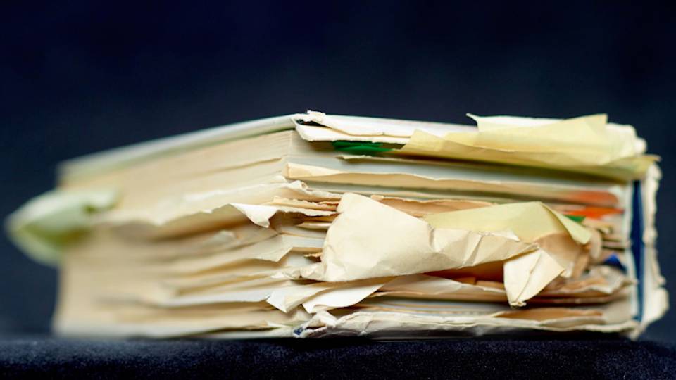 Old book filled with stickies marking pages