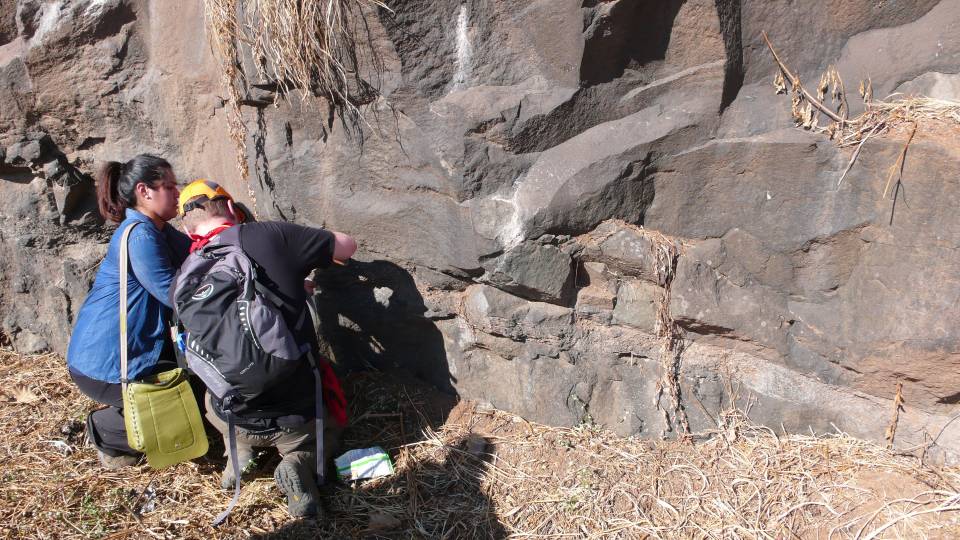 Students taking samples from volcano wall