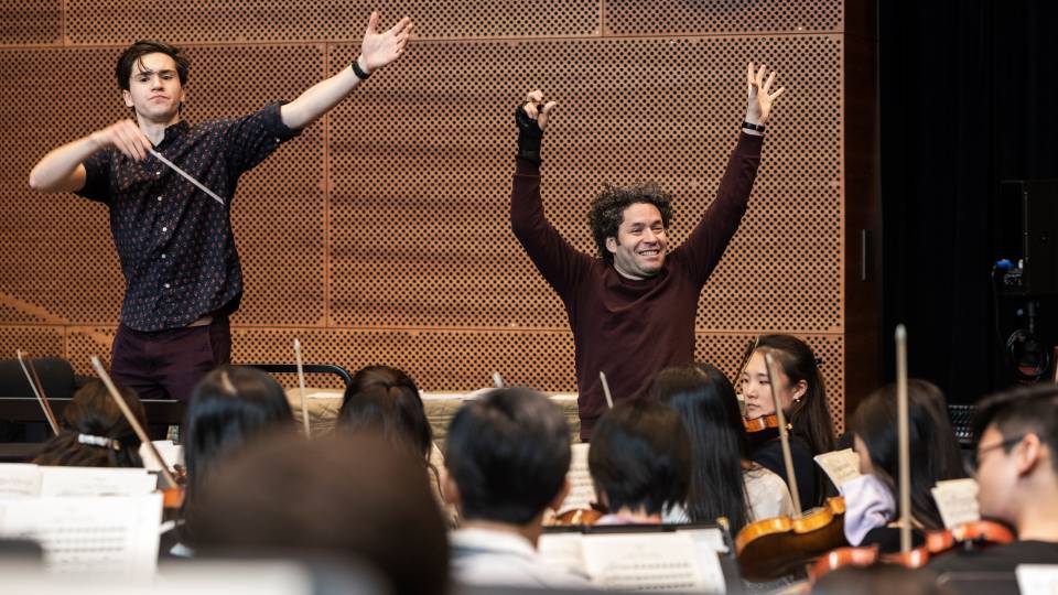 Reilly Bova and Gustavo Dudamel conducting orchestra