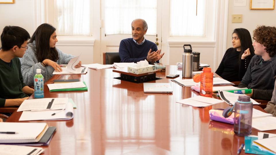 Pico Iyer and students sitting around table