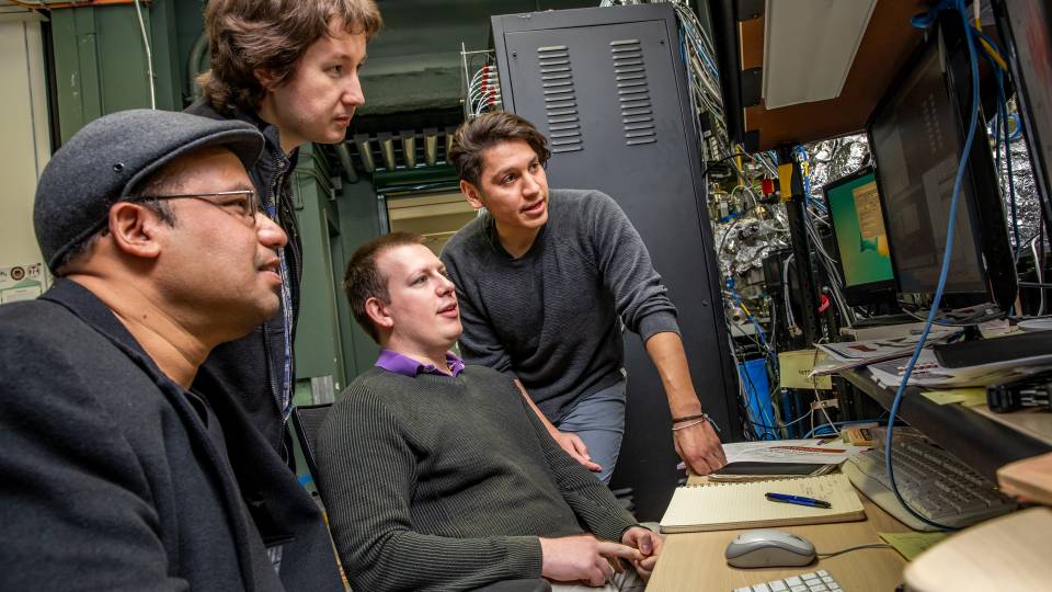 Zahid Hasan and his research team gathered around a computer
