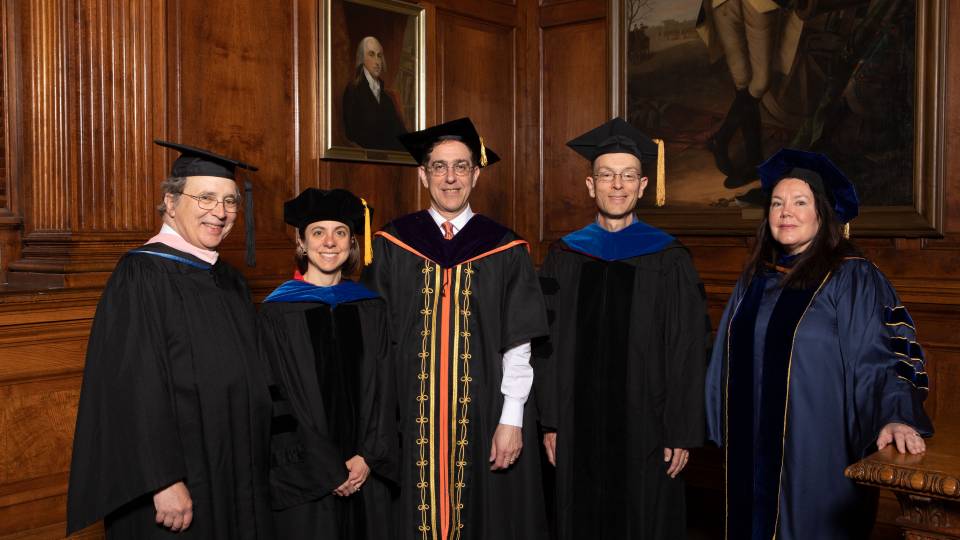 Recipients of faculty teaching awards pose in their ceremonial robes and mortarboards