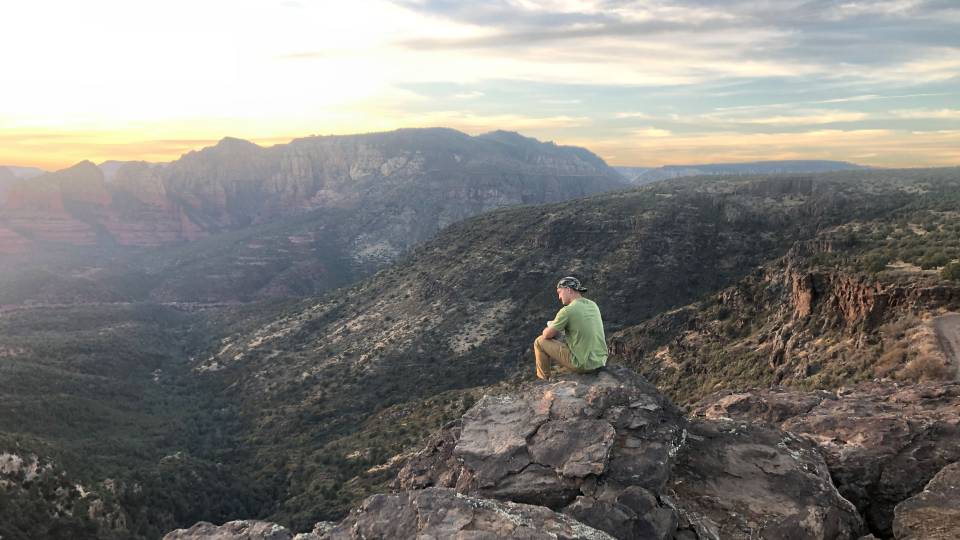 Person sitting on mountaintop in Sedona, Arizona