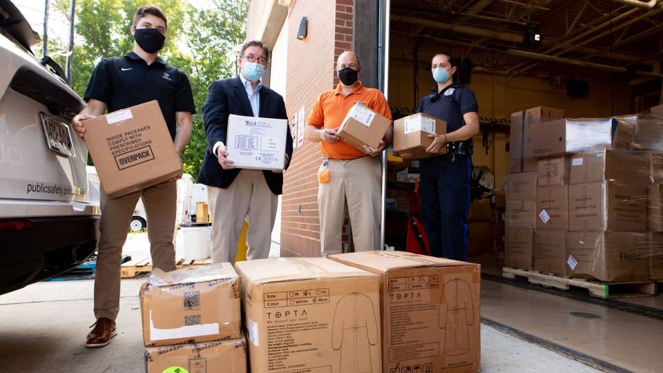 volunteers load boxes of PPE