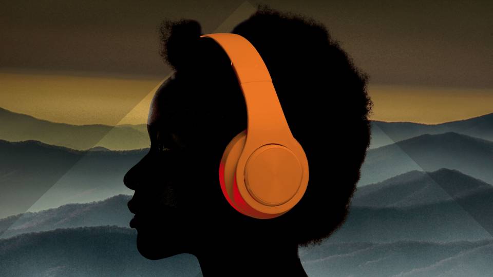 A silhouette of a person wearing headphones with a background of a mountain range
